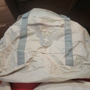 Cream and Gray Duffel Bag Pocket On Front To Hold On Luggage. NEW.  Never Used